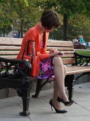 Woman in black heels on a bench